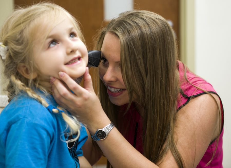 Student Doctor examining child