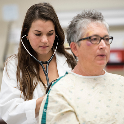 medical student examining a patient in the clinic